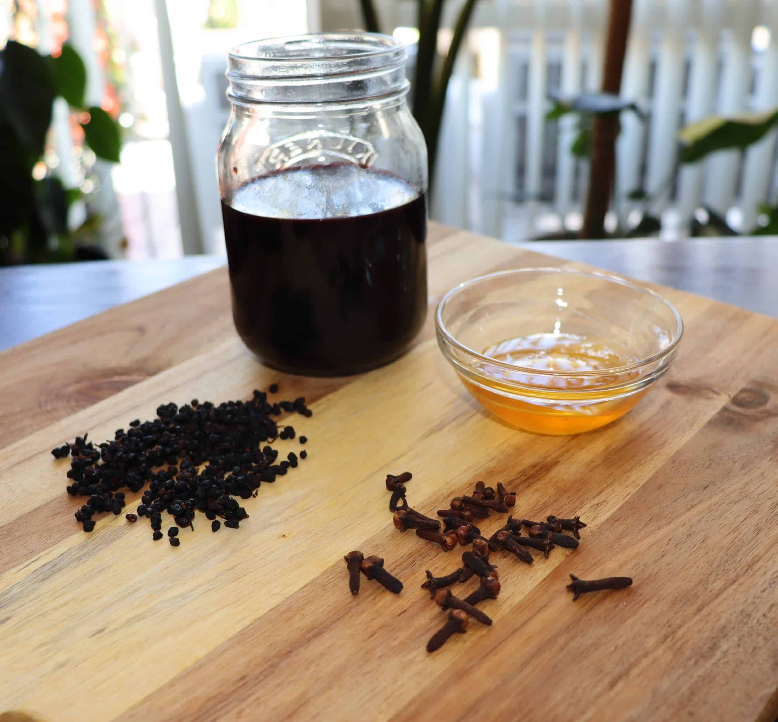 Elderberries, honey and cloves on table