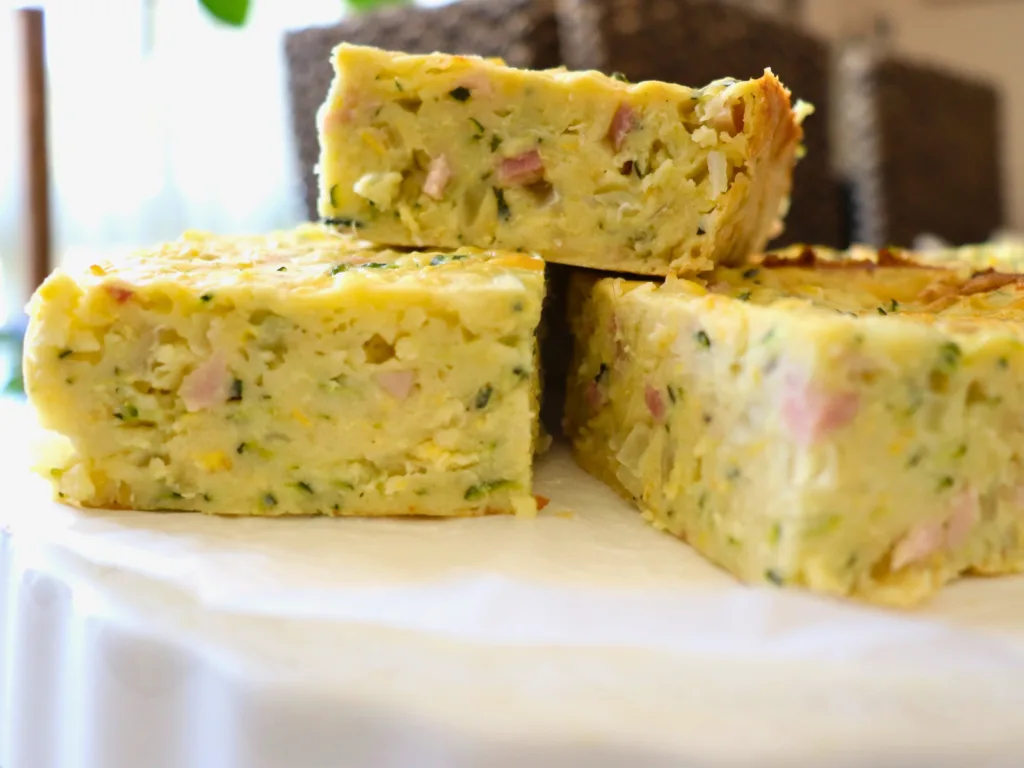 zucchini slices stacked on top of white plate